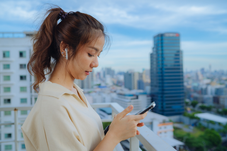 Time to Relax. Asian Girl in Airpods Listening Music Online on Smartphone at home